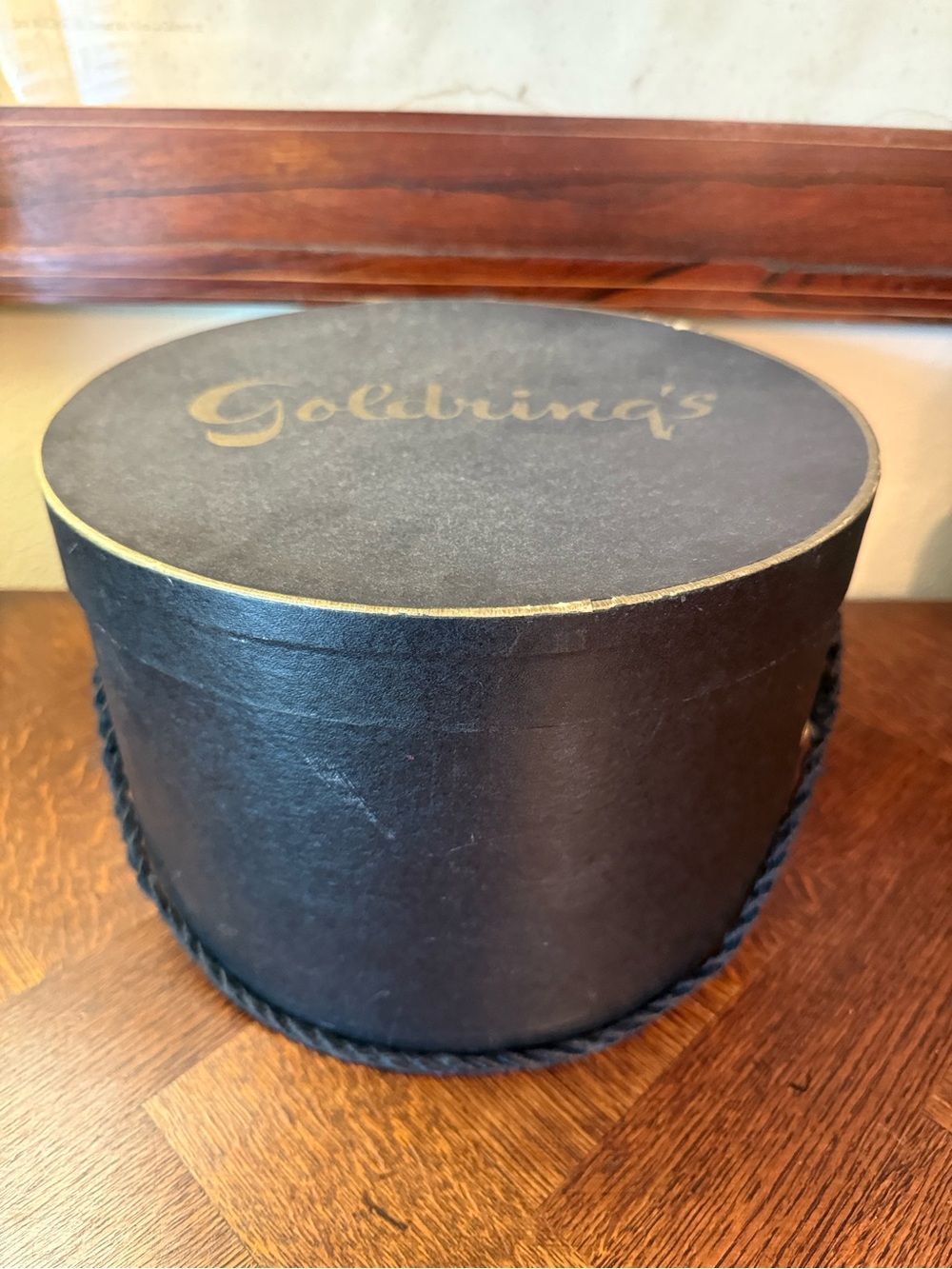 Goldring's Round Black Hat Box with Rope Trim